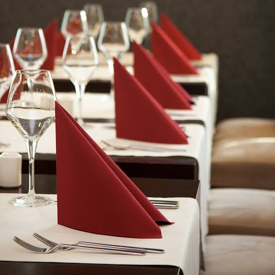 Crimson satin napkin on a fine-dining place setting